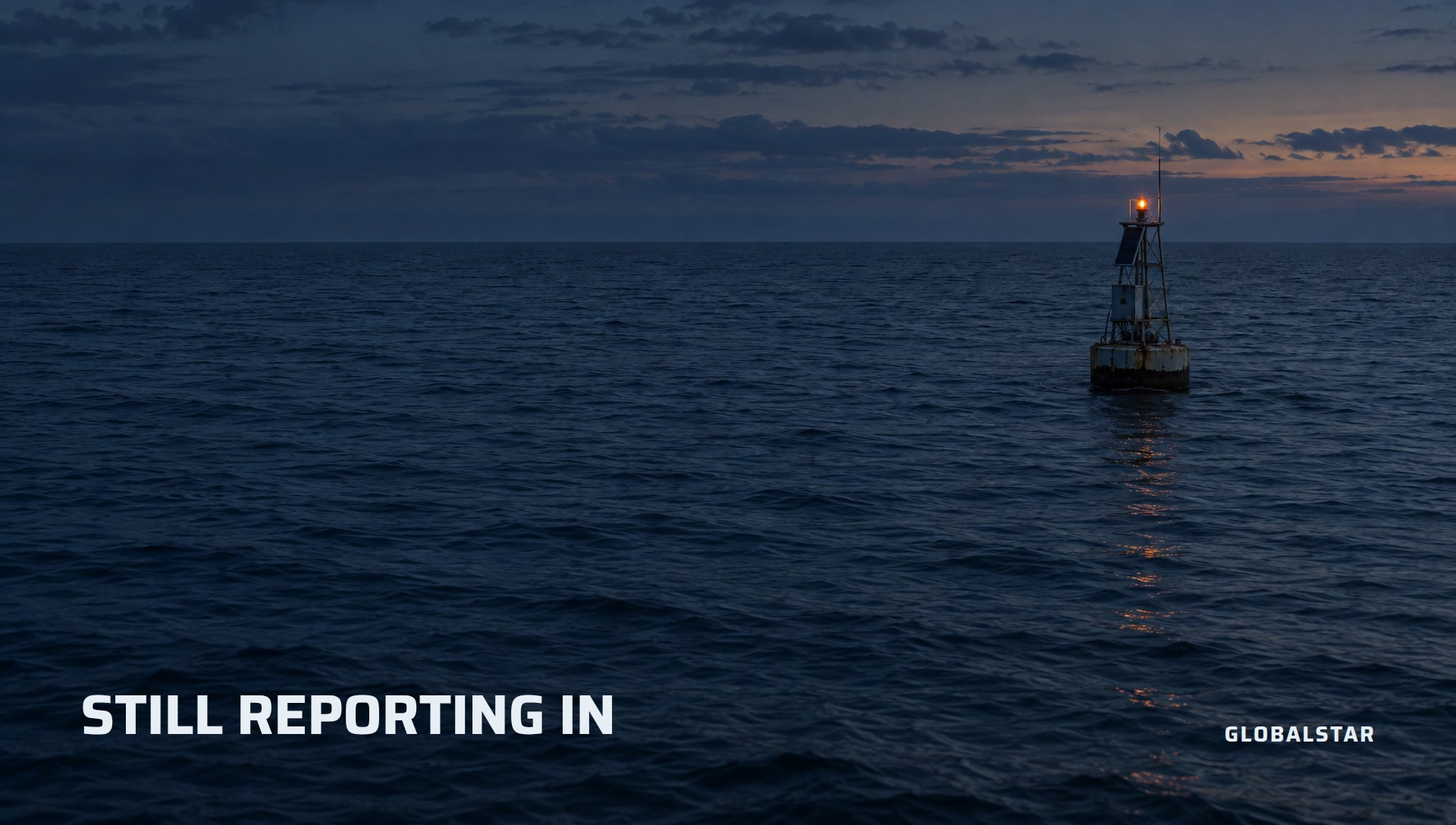 A lone monitoring buoy far out on dark water with a single status light